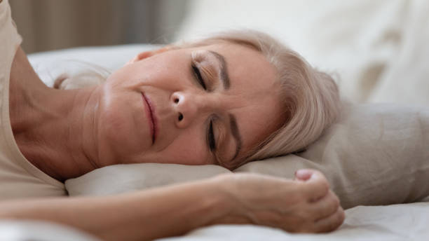 istock Close up view sleeping middle-aged woman lying on pillow 1191287601