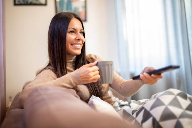 istock Young woman is watching television. 1191288876