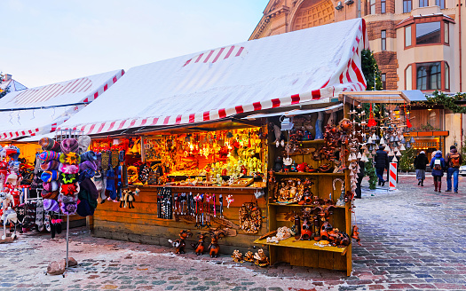 Christmas Ceramics Decorations on Christmas Market at Riga, Latvia. Advent Fair, and Stalls with Crafts Items in Bazaar. Night street Xmas and holiday fair in European city or town, December.