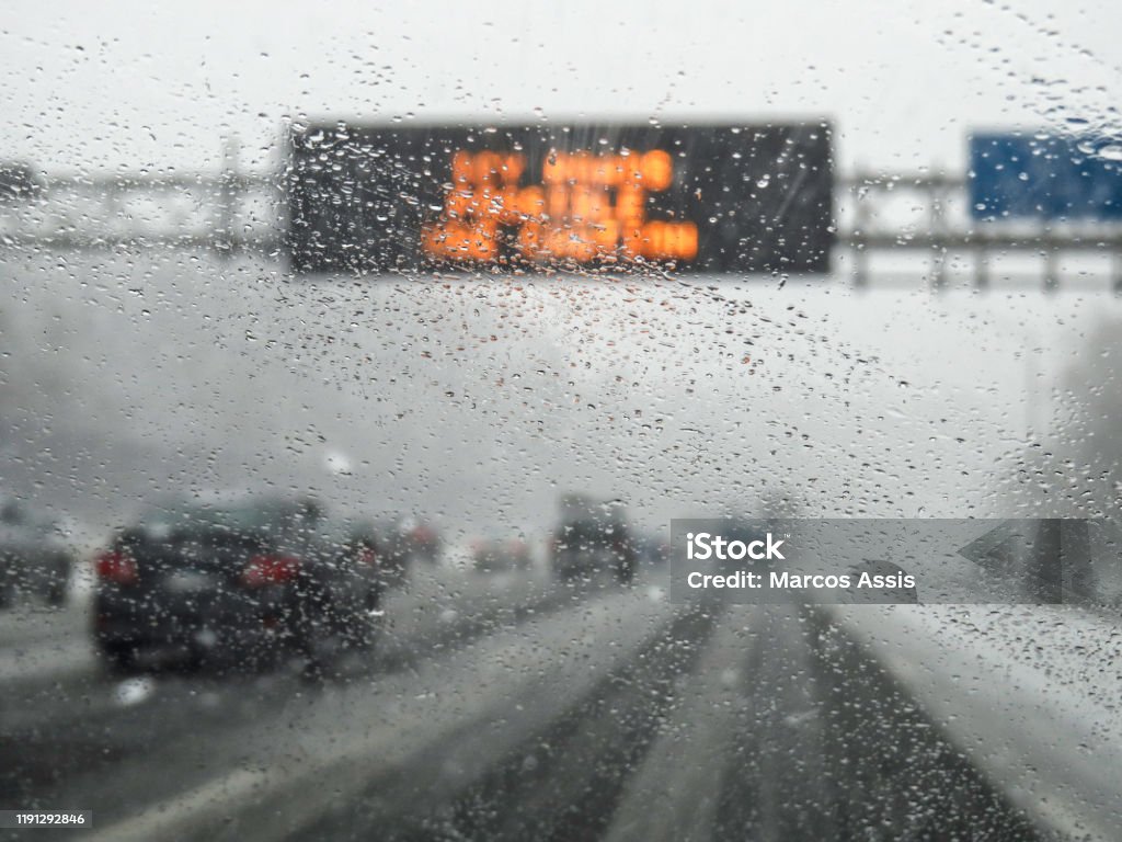 hazardous weather condition on the road seen through windshield Road Stock Photo