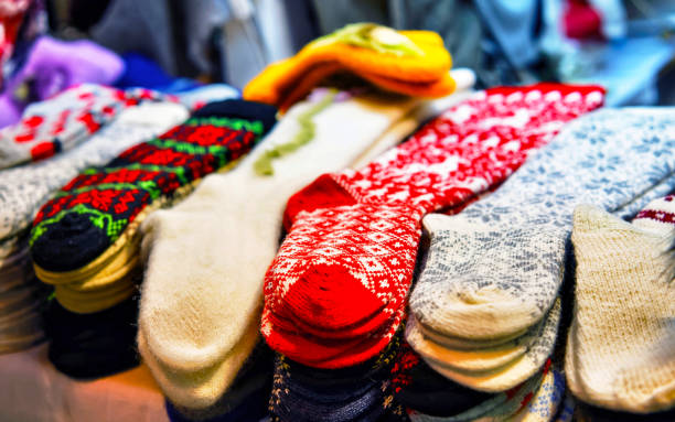 Socks made from wool at stalls during Christmas Market in Riga, Latvia in winter. Street Xmas and holiday fair in European city or town. Advent Decoration with Crafts Items on Bazaar