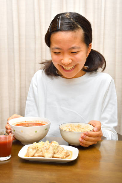 istock Japanese girl enjoys having dinner 1191293653