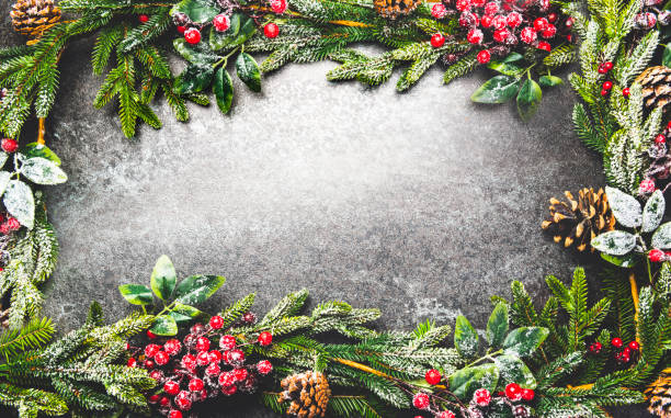 istock Christmas black background with snowy fir tree and cones 1191293688