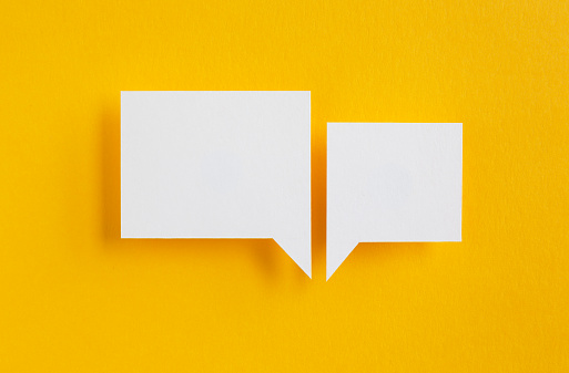 paper speech bubbles on yellow background