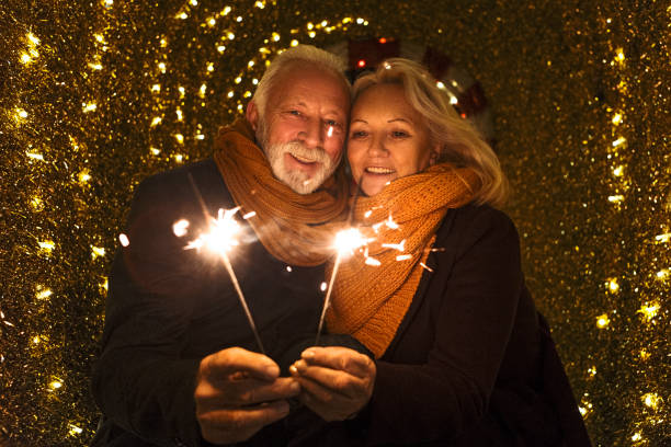 istock Senior couple with sparklers on Christmas 1191308052