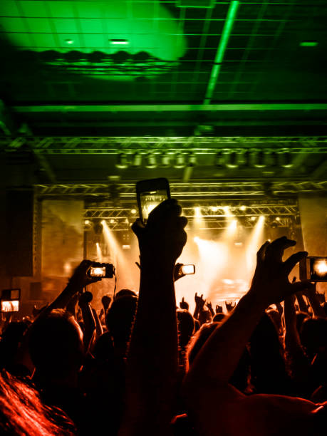 concert stage, people are visible waving and clapping, silhouettes are visible - concert hall crowd dancing nightclub imagens e fotografias de stock