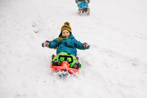 istock Cute little boy sledding on the snowy mountain 1191312329