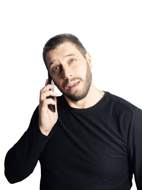 istock Pretty man with a beard talking on the phone on a white background 1191314707
