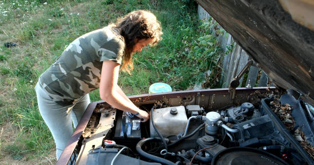 istock woman fixing her old car 1191316755