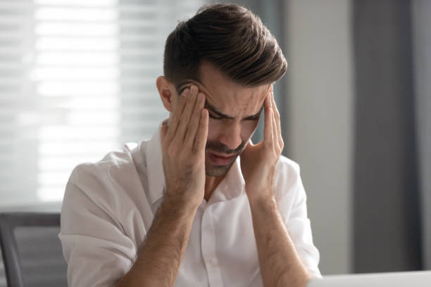 istock Unhappy businessman massaging temples, suffering from strong headache 1191319835