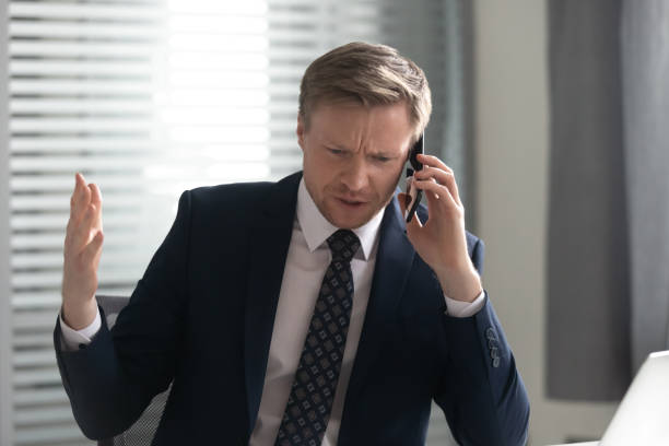 istock Unhappy angry businessman talking on phone, solving business problem 1191319857