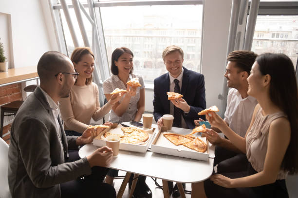 istock Happy diverse employees having fun, enjoying pizza together 1191319926