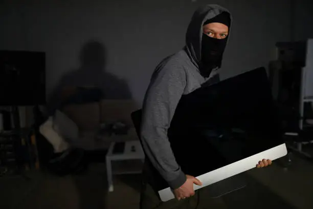 Photo of Thief stealing electronics