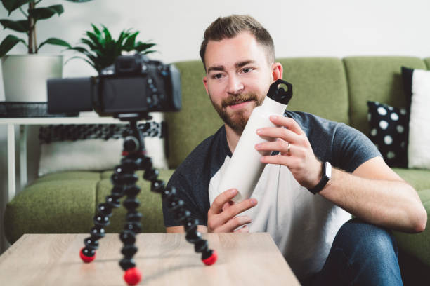 istock Bearded man filming a video with a water bottle 1191320198