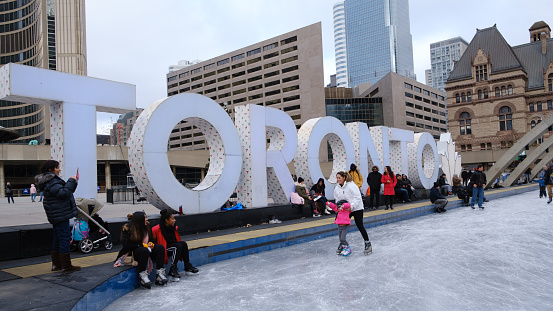 Winter Ice Skating at Nathan Phillips Square in downtown Toronto, Ontario.