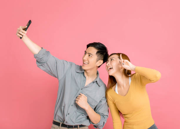 istock happy young couple making selfie with smart phone 1191323110