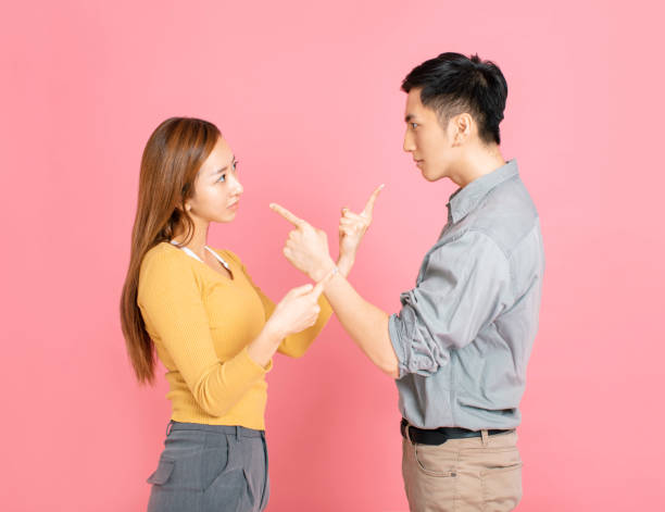 istock Angry couple pointing at each other while arguing 1191323116