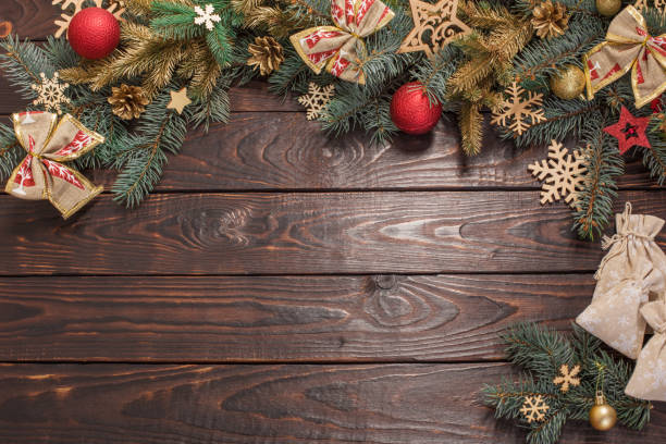 istock fir branches with Christmas decor on old dark wooden background 1191324837