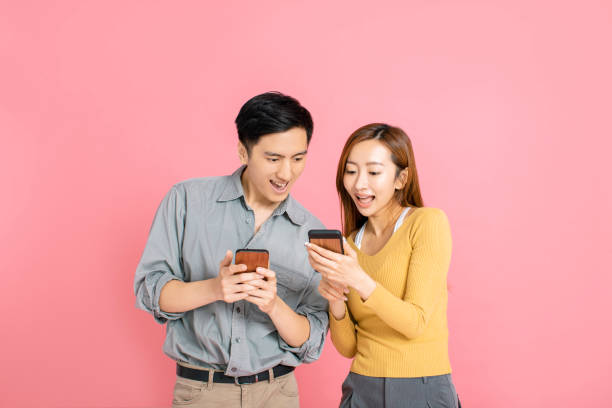 istock Cheerful young couple watching the smart phone 1191325449