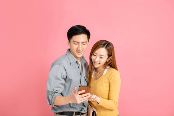 istock Cheerful young couple watching  the smart phone 1191325574