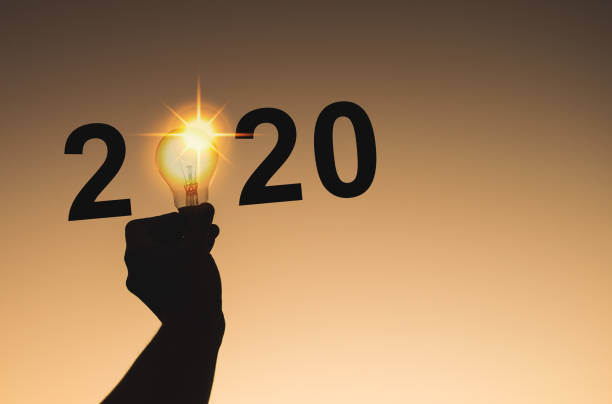 istock 2020 New Year celebration with part of human hand holding light bulb 1191329224