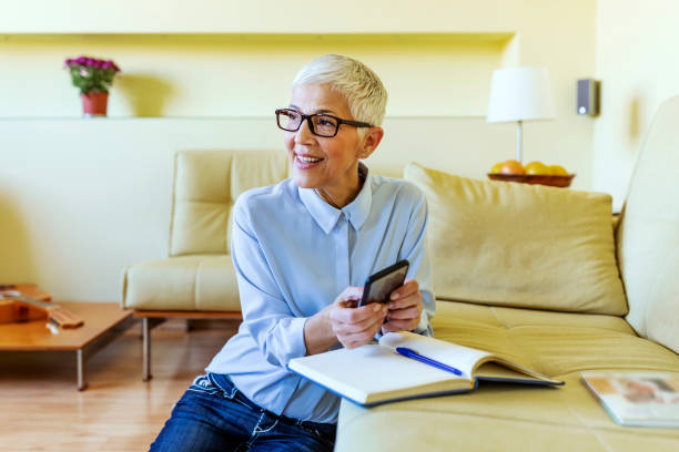 istock Women on smart phone and writing notes 1191329360