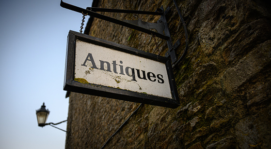 A sign that advertises antiques for sale.