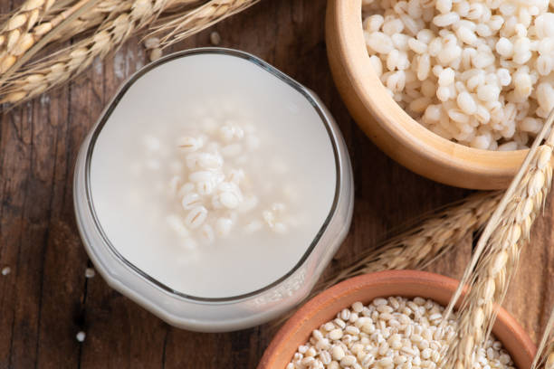 Barley water in glass with raw and cooked stock photo