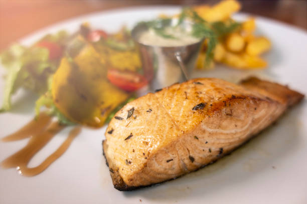 istock Grilled salmon salad with vegetables on white plate, selective focus. 1191345736