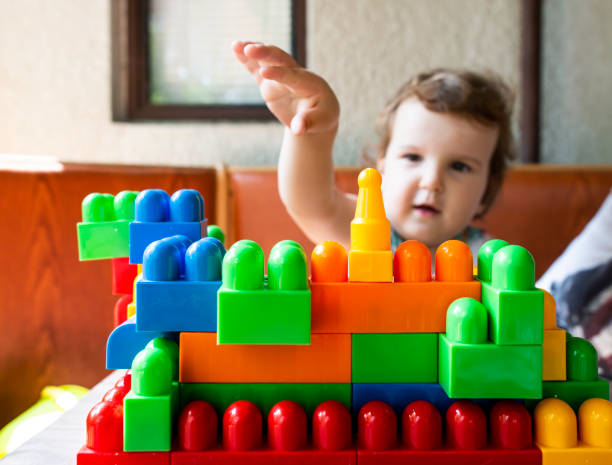 istock Little girl playing with toy blocks 1191346698