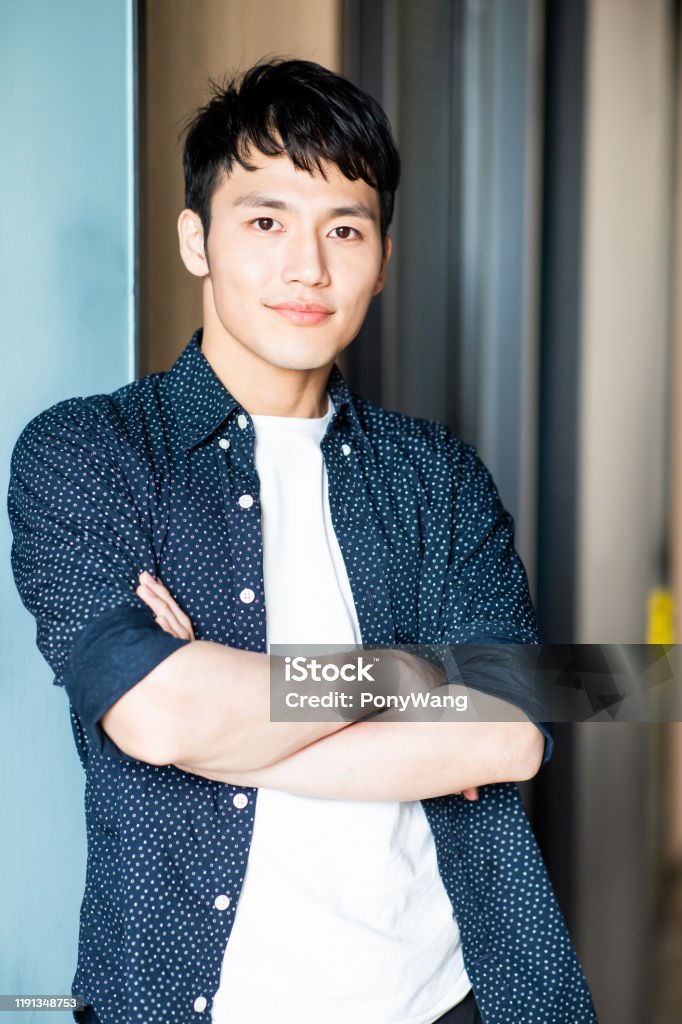young man look to you asian young man look to you with charming smile Korean Ethnicity Stock Photo