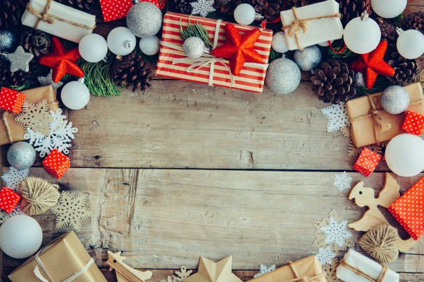 istock Christmas background with gift boxes and decorations on the wooden table 1191349799