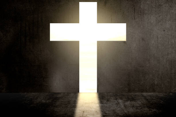 Black wall with Christian cross shape with sunlight background
