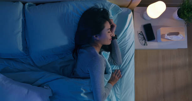 asian woman sleep well overlooking of asian woman sleep well with smile at night woman sleeping in bed at night stock pictures, royalty-free photos & images
