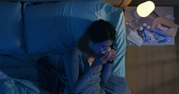 asian woman sneezed on bed overlooking of asian woman has illness from colds or flu and sneezed on bed at night bed of hay stock pictures, royalty-free photos & images