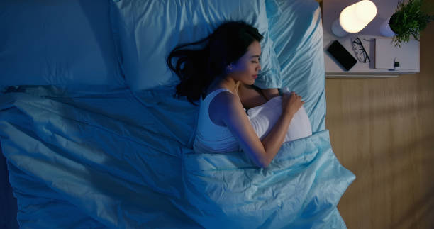 asian woman sleep well overlooking of asian woman sleep well with smile at night overlooking of asian woman sleep well with smile at night woman sleeping in bed at night stock pictures, royalty-free photos & images
