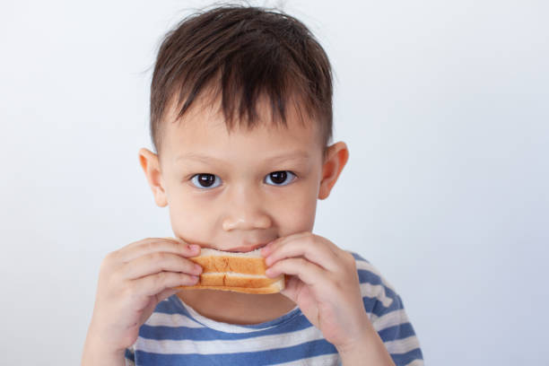 istock Asian little boy eating bread before go to school 1191351278