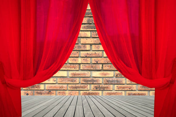 istock Illuminated theater stage   Red colored stage curtain 1191354113