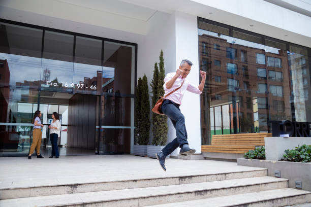 Success businessman jumping at the office stock photo