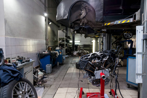 istock Replacement used engine mounted on a crane for installation on a car after a breakdown near vehicle on lift. Auto service industry. 1191355971