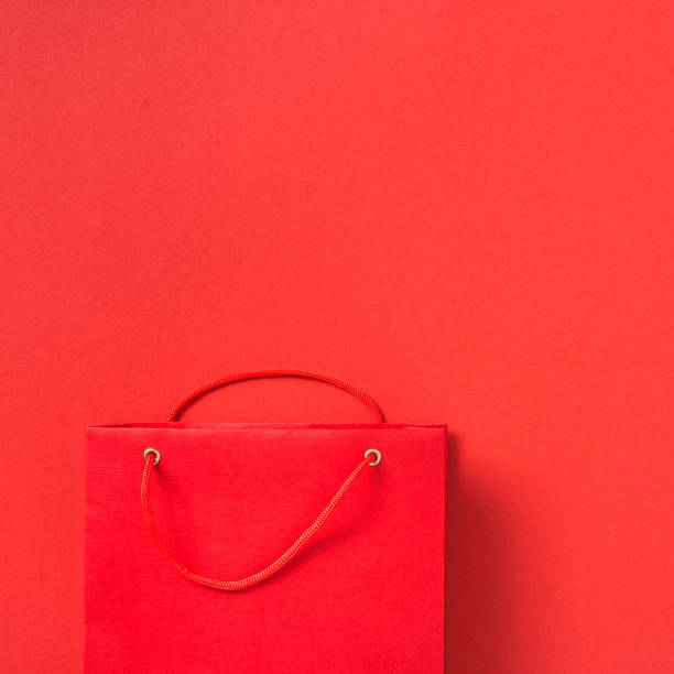 istock Empty red paper bag on red background top view 1191359703