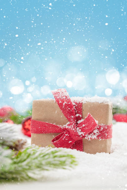 istock Christmas greeting card with gift box in snow 1191359773