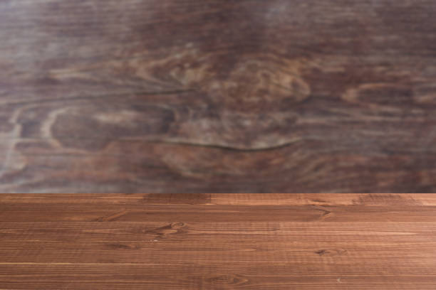 istock Wooden board empty table in front of a blurred background. Perspective brown wood over blurred wooden planks background - can be used to showcase or assemble your products. Mock up 1191361013