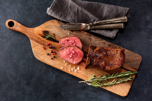 istock Roast beef on a wooden board 1191364812