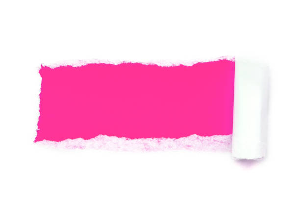 a hole in white paper with torn edges isolated on a white background with a bright pink color paper background inside. - note rose image saturated color imagens e fotografias de stock