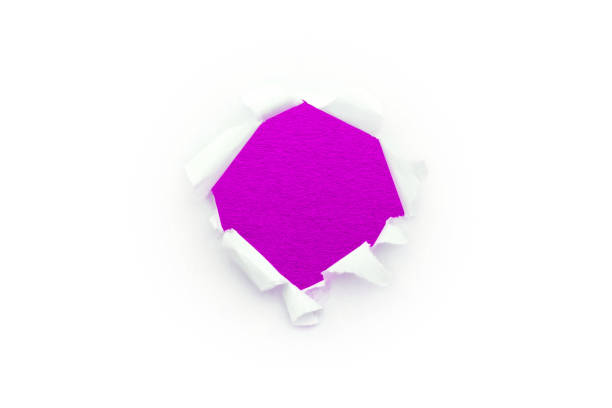 a round hole in white paper with torn edges isolated on a white background with a bright violet color paper background inside. good paper texture. - note rose image saturated color imagens e fotografias de stock