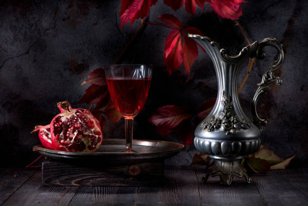 Still life with red wine and pomegranate