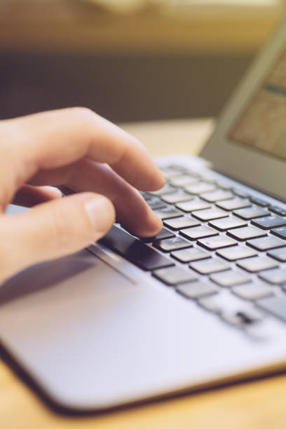 istock Hand using laptop at a wooden table. Copy space 1191370650
