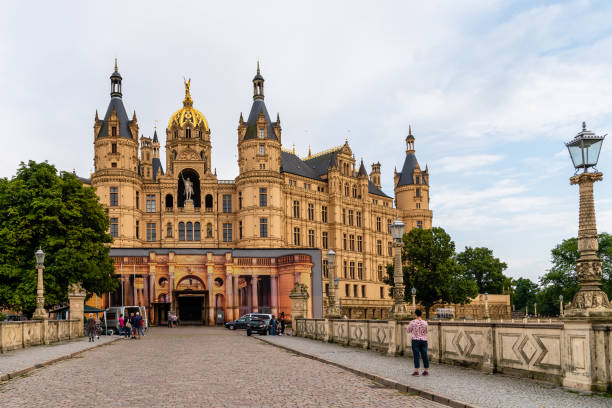 Schwerin, Germany - February 18, 2018: Schwerin Castle on a frozen lake under colorful clouds. Mecklenburg-Vorpommern