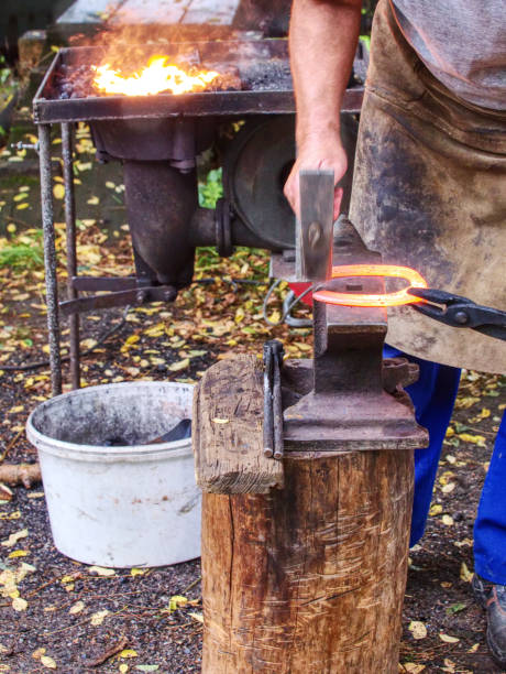 istock Farm smithy. Blacksmith processes metal with  sledgehammer 1191372163